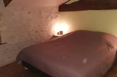 Un ou plusieurs lits dans un hébergement de l'établissement Maison charentaise à la campagne