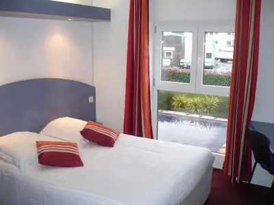 Un ou plusieurs lits dans un hébergement de l'établissement Agape Hotel Niort- Bessines