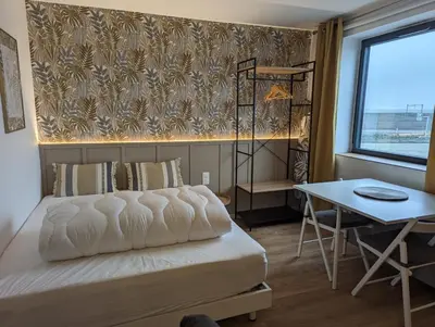 Un ou plusieurs lits dans un hébergement de l'établissement Échappée Cosy au Cœur du Futuroscope - Confort Assurés