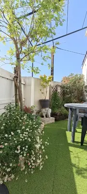 Jardin de l'établissement Charmante maisonnette proche plage