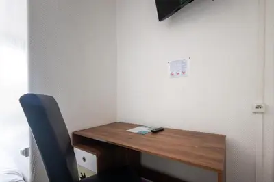 Télévision ou salle de divertissement dans l'établissement Hôtel Le Cheval Blanc