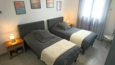 Un ou plusieurs lits dans un hébergement de l'établissement La Tulipe Maison à deux pas de la mer