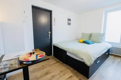 Un ou plusieurs lits dans un hébergement de l'établissement Le Cocoon, studio centre, wifi, stationnement
