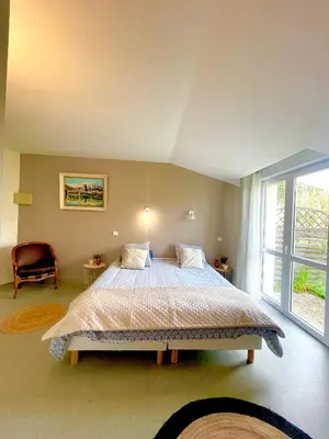 Un ou plusieurs lits dans un hébergement de l'établissement Domaine de Laléard Chambres de charme au calme absolu
