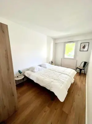 Un ou plusieurs lits dans un hébergement de l'établissement Superbe appartement avec parking