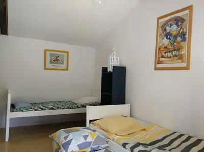 Un ou plusieurs lits dans un hébergement de l'établissement Charmante maison dans joli village