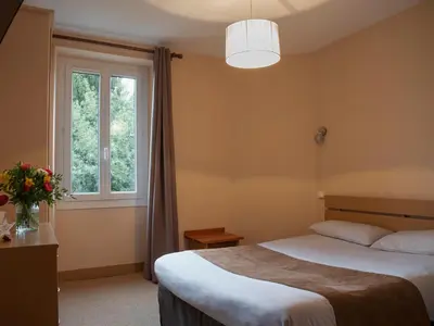 Un ou plusieurs lits dans un hébergement de l'établissement Hôtel des Pyrénées