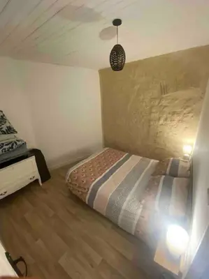 Un ou plusieurs lits dans un hébergement de l'établissement Petite maison plain-pied climatisé