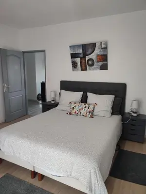 Un ou plusieurs lits dans un hébergement de l'établissement Charmante maison près du Futuroscope
