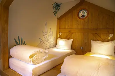 Un ou plusieurs lits dans un hébergement de l'établissement Hôtel Ecolodgee