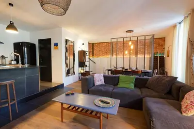 Coin salon dans l'établissement L'Olympe - triplex avec spa et rooftop Classé 4*