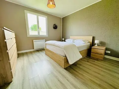 Un ou plusieurs lits dans un hébergement de l'établissement Au petit bonheur - Maison familiale au calme