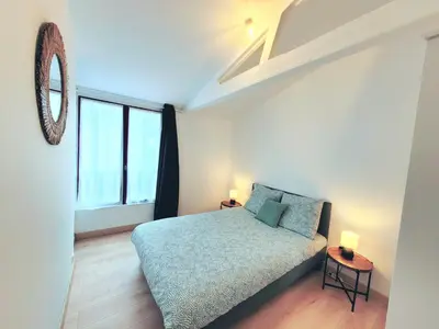 Un ou plusieurs lits dans un hébergement de l'établissement Appartement 2 chambres centre-ville avec terrasse