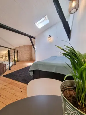 Un ou plusieurs lits dans un hébergement de l'établissement Duplex Le Chai de l'Abreuvoir