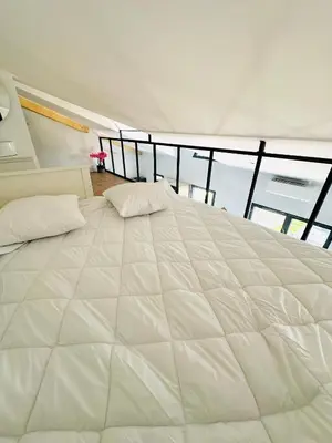 Un ou plusieurs lits dans un hébergement de l'établissement Villa front de mer avec jacuzzi et accès plage