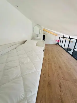 Un ou plusieurs lits dans un hébergement de l'établissement Villa front de mer avec jacuzzi et accès plage