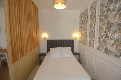 Un ou plusieurs lits dans un hébergement de l'établissement G2 Appartement Familial lumineux RDC centre Angouleme