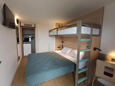 Un ou plusieurs lits dans un hébergement de l'établissement Premiere Classe Saintes