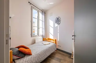 Un ou plusieurs lits dans un hébergement de l'établissement Maisonnette au cœur de Cognac