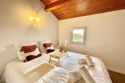 Un ou plusieurs lits dans un hébergement de l'établissement La Touzetterie avec SPA-cour privée