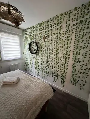 Un ou plusieurs lits dans un hébergement de l'établissement Paisible appartement proche futuroscope