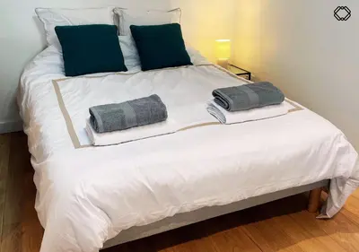 Un ou plusieurs lits dans un hébergement de l'établissement Studio Nid Urbain