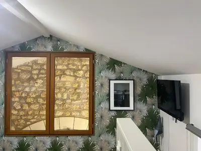 Télévision ou salle de divertissement dans l'établissement La Grange d'Antornac