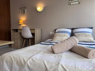 Un ou plusieurs lits dans un hébergement de l'établissement Appart-Hotel des coquillages Résidence Kiwi