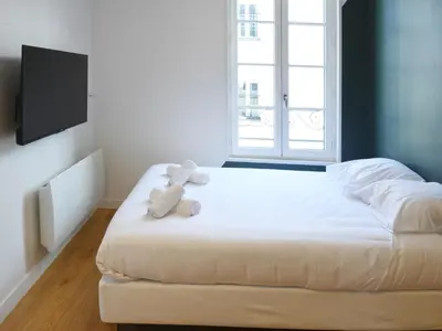Un ou plusieurs lits dans un hébergement de l'établissement Le Cocon studio, cognac