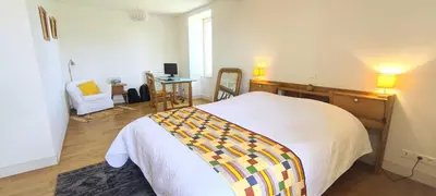 Un ou plusieurs lits dans un hébergement de l'établissement Gite 7 personnes à Montbron, Charente