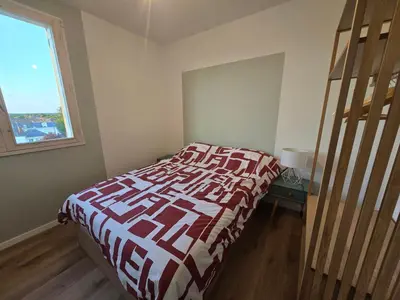 Un ou plusieurs lits dans un hébergement de l'établissement L'appartement de Julien