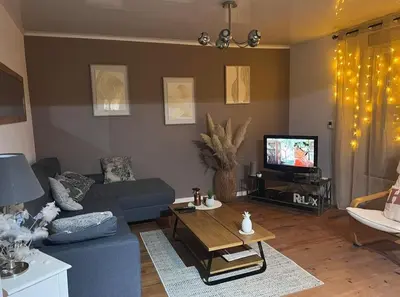 Télévision ou salle de divertissement dans l'établissement Maison de ville