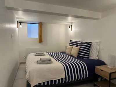 Un ou plusieurs lits dans un hébergement de l'établissement Chez Camille & Emma - Loft Climatisé
