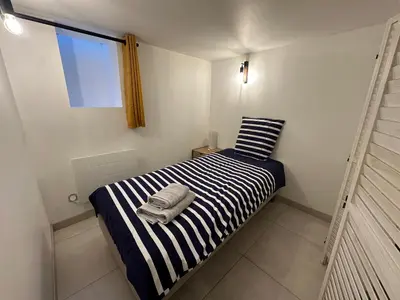 Un ou plusieurs lits dans un hébergement de l'établissement Chez Camille & Emma - Loft Climatisé