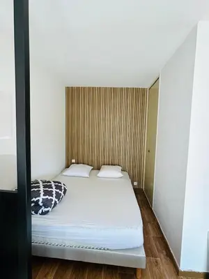Un ou plusieurs lits dans un hébergement de l'établissement Bel Air Appartement