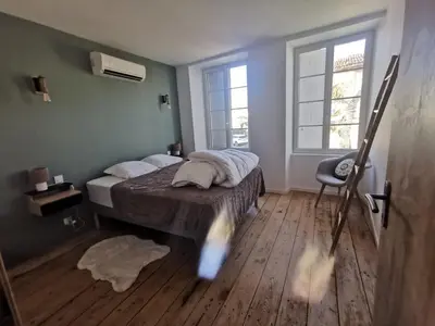 Un ou plusieurs lits dans un hébergement de l'établissement L'Aparté du Doué à Mauzé sur le Mignon