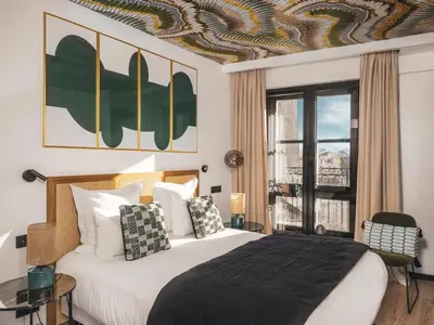 Un ou plusieurs lits dans un hébergement de l'établissement Maisons du Monde Hôtel & Suites - La Rochelle Vieux Port