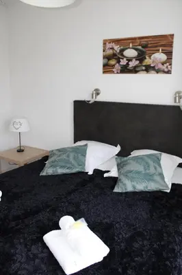 Un ou plusieurs lits dans un hébergement de l'établissement City Lodge Appart Hôtel Niort