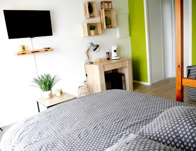 Un ou plusieurs lits dans un hébergement de l'établissement Futurostudio - Appart Hôtel Futuroscope - Poitiers