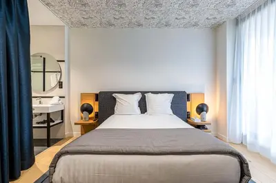 Un ou plusieurs lits dans un hébergement de l'établissement Hotel Le Saint Gelais