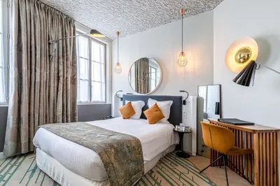 Un ou plusieurs lits dans un hébergement de l'établissement Hotel Le Saint Gelais