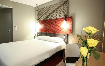 Un ou plusieurs lits dans un hébergement de l'établissement Ibis Niort Est Mendes France