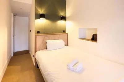 Un ou plusieurs lits dans un hébergement de l'établissement Hôtel Henri IV