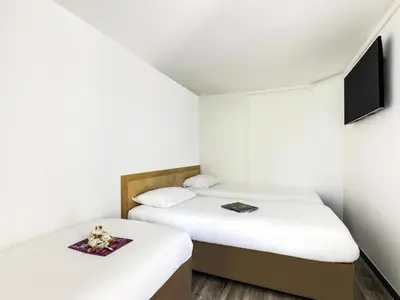 Un ou plusieurs lits dans un hébergement de l'établissement greet hôtel Angoulême