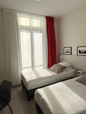 Un ou plusieurs lits dans un hébergement de l'établissement Hôtel La Fabrique