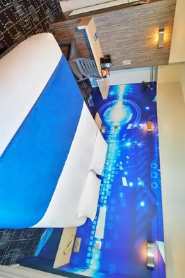 Un ou plusieurs lits dans un hébergement de l'établissement Kyriad Poitiers Jules Verne Site du Futuroscope