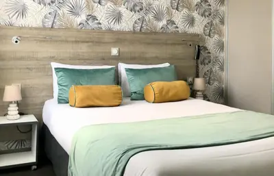 Un ou plusieurs lits dans un hébergement de l'établissement Boutique Hôtel d'Orbigny Chatelaillon - La Rochelle