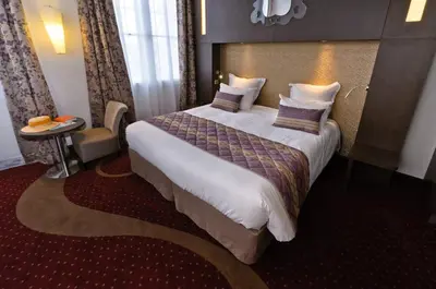 Un ou plusieurs lits dans un hébergement de l'établissement Hôtel François Premier Cognac Centre