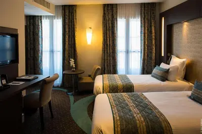 Un ou plusieurs lits dans un hébergement de l'établissement Hôtel François Premier Cognac Centre
