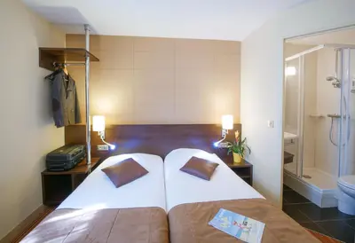 Un ou plusieurs lits dans un hébergement de l'établissement Hôtel Inn Design & Restaurant Poitiers